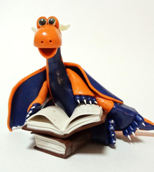 Orange and blue dragon with books figurine