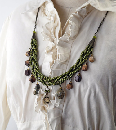 Metallic green beaded braided necklace with assorted sea themed charms