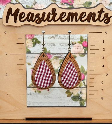 Checkered fabric teardrop shaped earrings on measurement stand