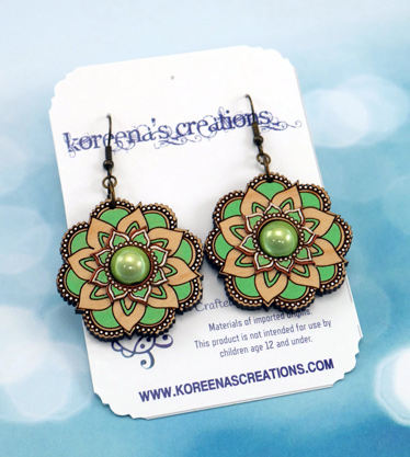 Light green and natural wood flower mandala earrings on display card