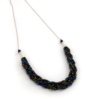Oil spill coloured beaded braided statement necklace on white background
