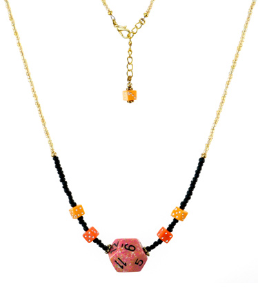 Orange and black beaded dice necklace on white background