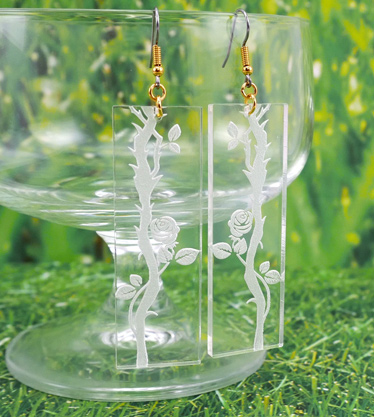 Clear acrylic dangle earrings with rose thorn engravings