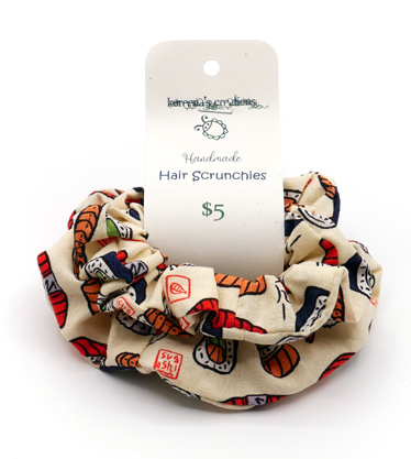 Package of scrunchies with cartoon sushi print